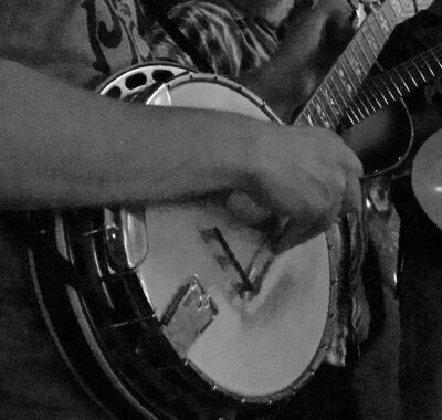 Close-up black and white photograph of a banjo